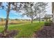 Landscaped backyard with pond and community view at 4206 Vicenza Dr # C24, Venice, FL 34293