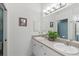 Bathroom with double vanity and a large mirror at 4206 Vicenza Dr # C24, Venice, FL 34293
