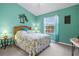 Bedroom with a full-size bed and a tropical-themed decor at 4206 Vicenza Dr # C24, Venice, FL 34293