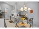 Bright dining area with glass-top table and four chairs near kitchen at 4206 Vicenza Dr # C24, Venice, FL 34293