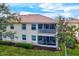 Back exterior view of villa, featuring a screened-in patio at 4206 Vicenza Dr # C24, Venice, FL 34293
