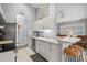 Open kitchen with white cabinets, stainless steel appliances, and breakfast bar at 4206 Vicenza Dr # C24, Venice, FL 34293
