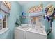 Bright laundry room with washer, dryer, and utility sink at 4206 Vicenza Dr # C24, Venice, FL 34293
