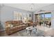 Spacious living room with leather sofas and sliding doors to balcony at 4206 Vicenza Dr # C24, Venice, FL 34293