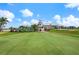 Clubhouse with putting green in the foreground at 447 Pinewood Lake Dr, Venice, FL 34285