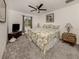 Bedroom with floral bedding and ceiling fan at 4743 Butterfly Ln, North Port, FL 34288
