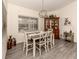 Charming dining room featuring a wooden hutch and white table with chairs at 4743 Butterfly Ln, North Port, FL 34288