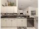 Kitchen boasts granite countertops and white cabinets at 4743 Butterfly Ln, North Port, FL 34288