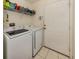 Laundry room with washer, dryer, and shelving at 4743 Butterfly Ln, North Port, FL 34288