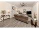 Relaxing living room with a large sectional sofa and hardwood floors at 4743 Butterfly Ln, North Port, FL 34288