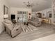 Open living room with comfortable seating and views of the pool at 4743 Butterfly Ln, North Port, FL 34288