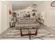 Bright and airy living room with a large sectional sofa and glass coffee table at 4743 Butterfly Ln, North Port, FL 34288