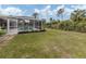 Large backyard with screened pool, patio, and lush landscaping at 4743 Butterfly Ln, North Port, FL 34288