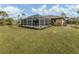 Screened pool with spacious deck and surrounding landscaping at 4743 Butterfly Ln, North Port, FL 34288