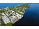 Aerial view of a waterfront property, showcasing homes and the coastline at 5055 N Beach Rd # 201, Englewood, FL 34223