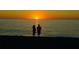Silhouette of couple watching sunset on beach at 5055 N Beach Rd # 201, Englewood, FL 34223