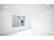 Empty bedroom with large window and simple white walls at 5055 N Beach Rd # 201, Englewood, FL 34223