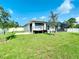 Large backyard with grassy area and screened patio at 5552 Guest Ter, Port Charlotte, FL 33981