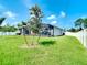 Spacious backyard with a screened patio and lush lawn at 5552 Guest Ter, Port Charlotte, FL 33981