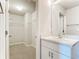 Bright bathroom features a vanity with a sink and access to a closet at 5552 Guest Ter, Port Charlotte, FL 33981