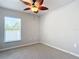 Well-lit bedroom with ceiling fan and window with blinds at 5552 Guest Ter, Port Charlotte, FL 33981
