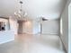 Open dining area with tile floor and modern chandelier at 5552 Guest Ter, Port Charlotte, FL 33981