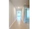 Long hallway with tile flooring and neutral-toned walls at 5552 Guest Ter, Port Charlotte, FL 33981