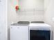 Laundry room with Whirlpool washer and dryer, plus shelving at 5552 Guest Ter, Port Charlotte, FL 33981