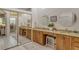 Elegant bathroom with dual vanities, granite countertops, and a walk-in shower at 560 Fallbrook Dr, Venice, FL 34292
