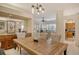 Spacious dining area with a wooden table and access to kitchen at 560 Fallbrook Dr, Venice, FL 34292