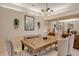 Bright dining room with a farmhouse style table and seating at 560 Fallbrook Dr, Venice, FL 34292