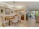 A well lit dining room with a wooden table and neutral decor at 560 Fallbrook Dr, Venice, FL 34292
