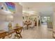 Open concept dining area with a wooden table and access to living room at 560 Fallbrook Dr, Venice, FL 34292