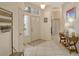 Bright and airy foyer with tile floors and coat rack at 560 Fallbrook Dr, Venice, FL 34292