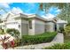 Tan house with a two-car garage and nicely landscaped yard at 560 Fallbrook Dr, Venice, FL 34292