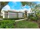 Single-story home with a landscaped lawn and walkway at 560 Fallbrook Dr, Venice, FL 34292
