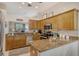 Modern kitchen with granite countertops and stainless steel appliances at 560 Fallbrook Dr, Venice, FL 34292