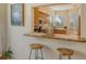 Kitchen features granite countertops, wooden cabinets, and a breakfast bar at 560 Fallbrook Dr, Venice, FL 34292