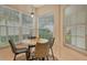 Breakfast nook with a round table and chairs near large windows at 560 Fallbrook Dr, Venice, FL 34292