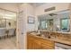 Kitchen with double sink, granite countertops, and a view into dining area at 560 Fallbrook Dr, Venice, FL 34292