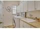 Bright laundry room with washer, dryer, and cabinets at 560 Fallbrook Dr, Venice, FL 34292