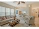 Bright living room features comfortable seating, a coffee table, and a view into the kitchen at 560 Fallbrook Dr, Venice, FL 34292