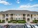 Two-story building with parking lot and lush landscaping at 5800 Sabal Trace Dr # 501, North Port, FL 34287