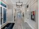 Elegant hallway with modern light fixtures and artwork at 6260 Talon Preserve Dr, Nokomis, FL 34275