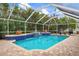 Sparkling screened pool with tile accents and a water feature at 629 Cornwell On The Gulf, Venice, FL 34285