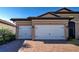 Two-car garage with brick driveway and tan house exterior at 629 Maraviya Blvd, Nokomis, FL 34275