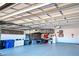 Bright garage with overhead storage and epoxy flooring at 629 Maraviya Blvd, Nokomis, FL 34275