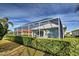 Home features a screened lanai, lush landscaping, and spacious backyard at 660 Silk Oak Dr, Venice, FL 34293