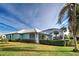 Home features a screened lanai, hedges, and a spacious backyard at 660 Silk Oak Dr, Venice, FL 34293