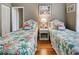 Bedroom with twin beds and tropical bedding at 660 Silk Oak Dr, Venice, FL 34293